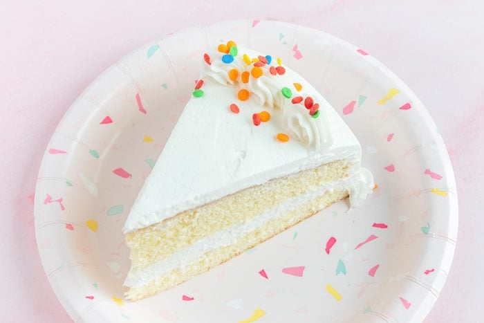 slice of cake from kroger on a plate on pink background