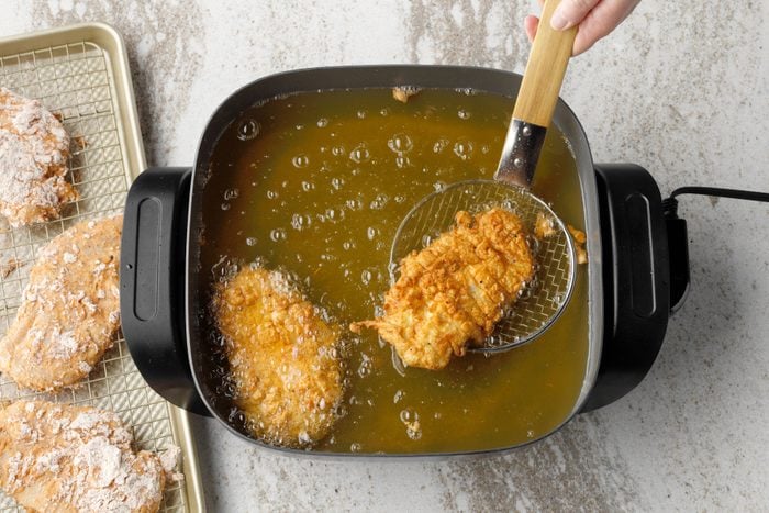 Chicken Cooking In Skillet Cooking With Coating Almost To A Golden Brown